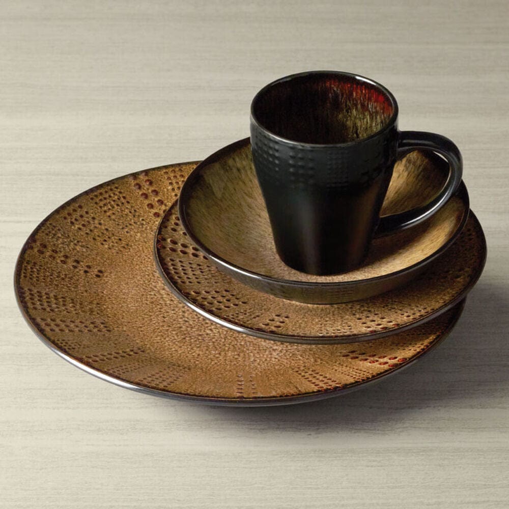 Brown Linden dinnerware set arranged on a light surface with a dark textured mug atop nested plates.