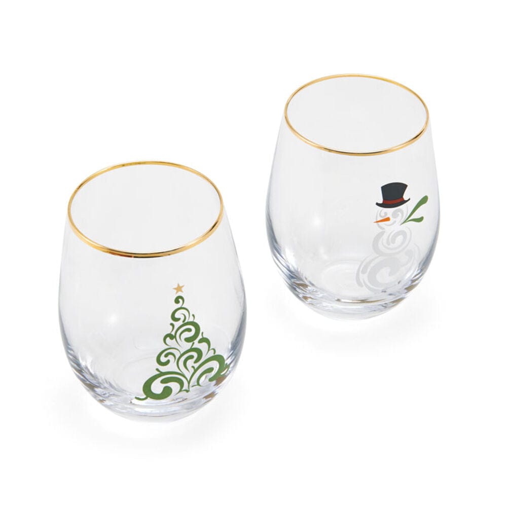 Two stemless wine glasses with a green Christmas tree design and a snowman motif on clear glass