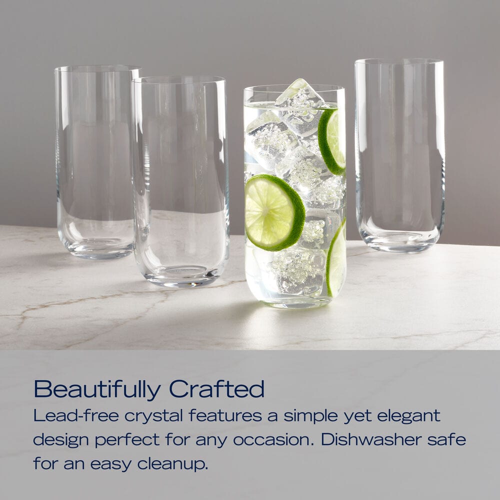 Set of four Upton highball glasses arranged on a marble surface with the center glass filled with ice and lime slices