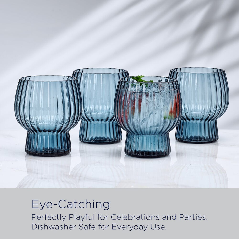 Group of four blue optic ribbed double old fashioned glasses displayed together on a white surface