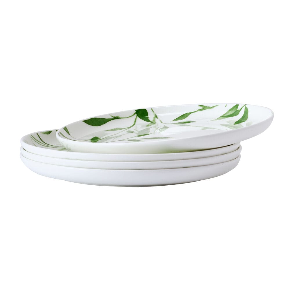 Stack of white Akira Vegan Bone salad plates with the same green leaf design