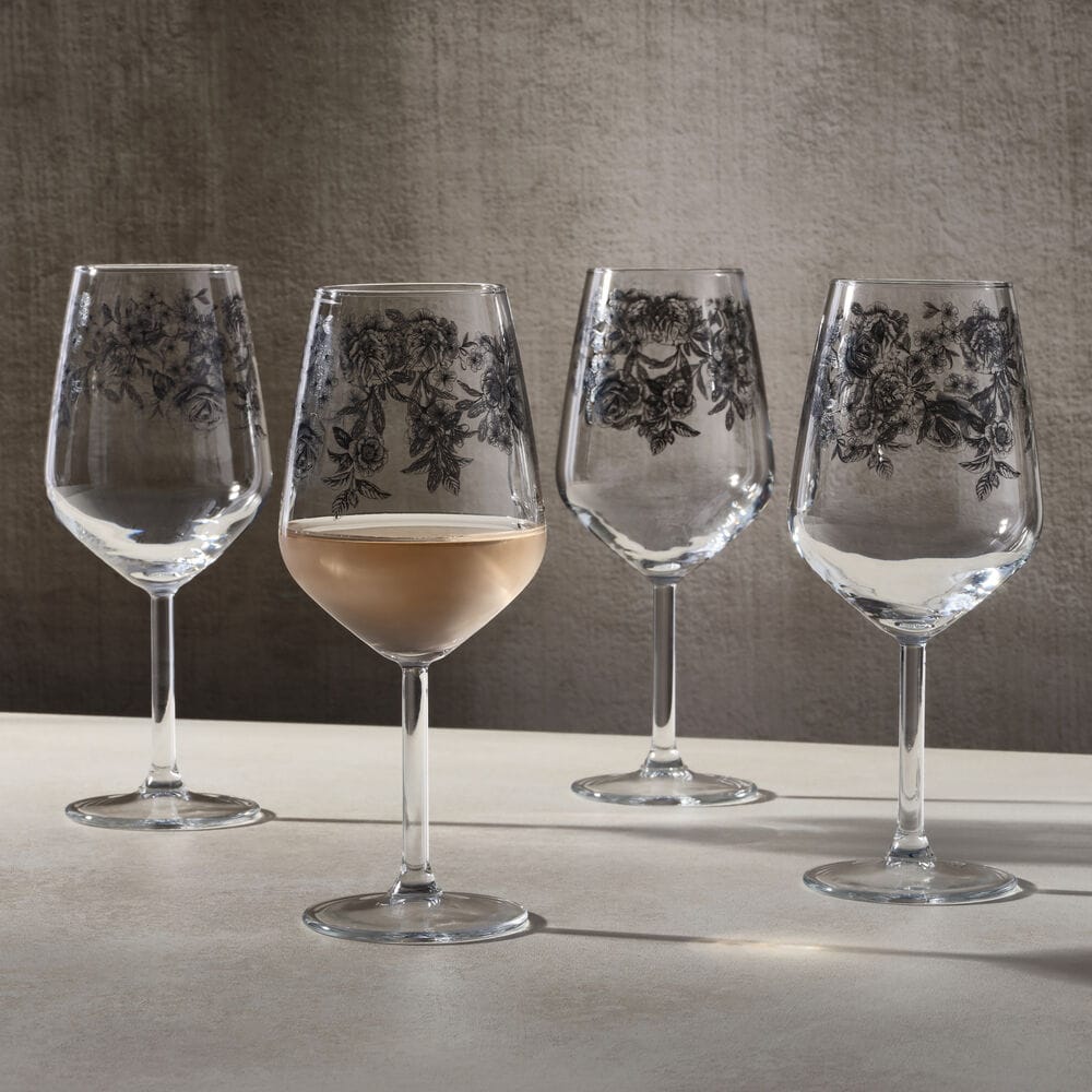 Empty Windsor Rose wine glasses with the same black floral pattern displayed against a neutral background