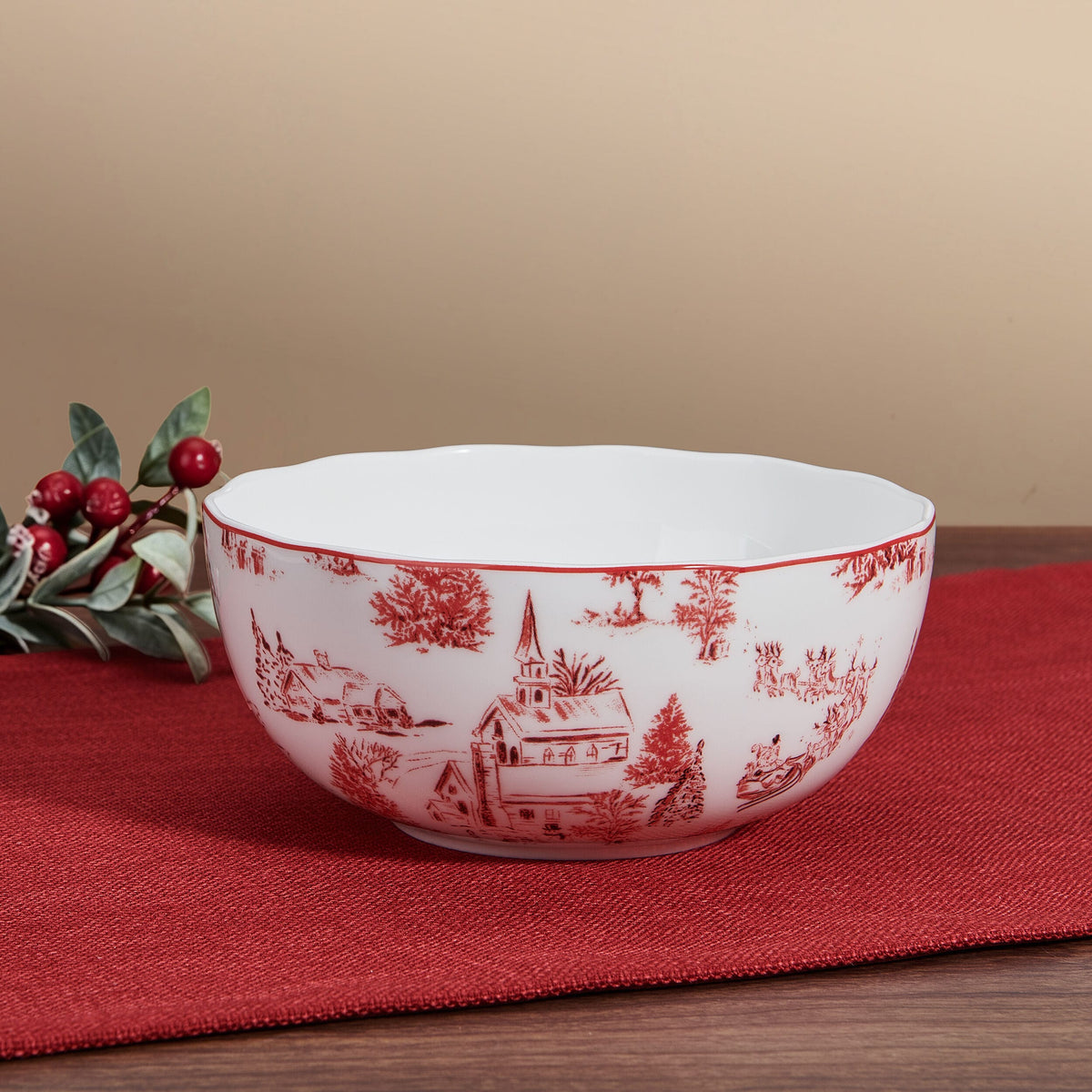 Close up of Holiday Village bowl featuring red winter print against beige background with cranberry sprigs