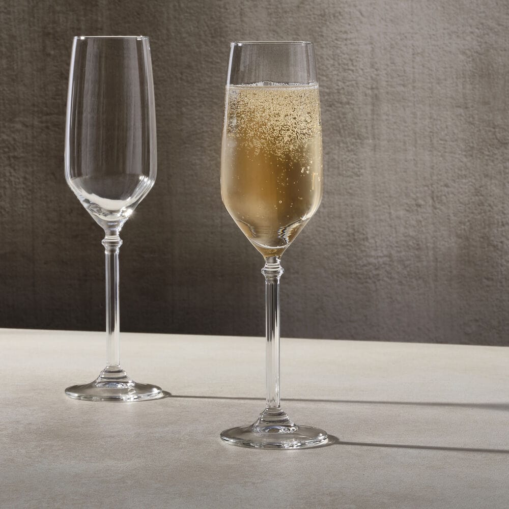 Two Eloise champagne flute glasses on a light surface