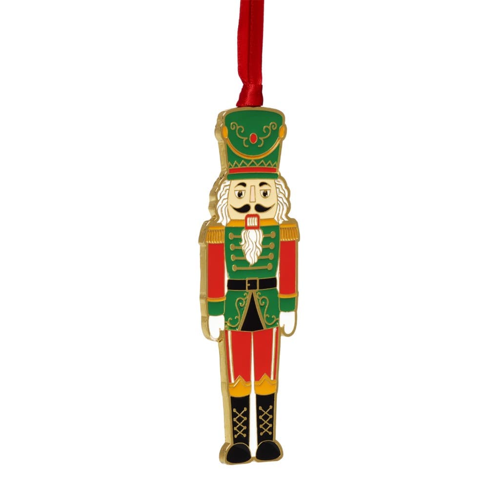 Nutcracker ornament in a green uniform with red pants and gold trim hanging from a red ribbon