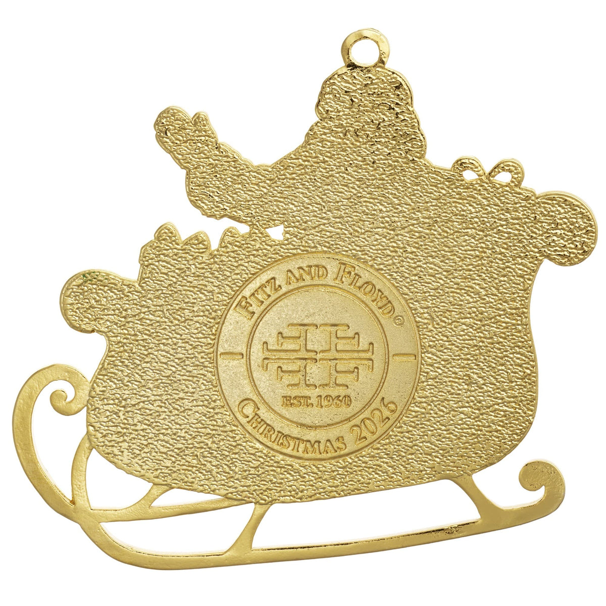 Close up of a gold plated enameled Santa ornament showing textured surface and hanging loop