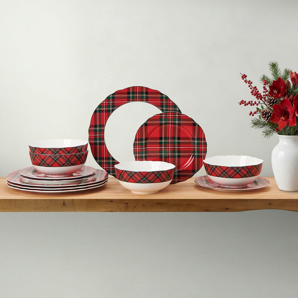 Tartan Red Scallop 12 Piece Dinnerware Set for 4 arranged on a wooden shelf with bowls and plates.