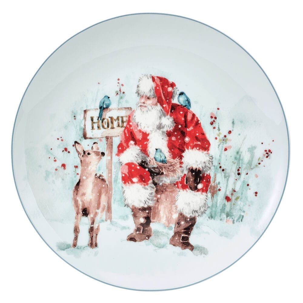 Santa in a red suit with a deer and blue birds beside a HOME sign in a snowy scene on a decorative salad plate.