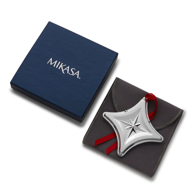 Mikasa blue gift box beside a gray pouch holding the silver star ornament