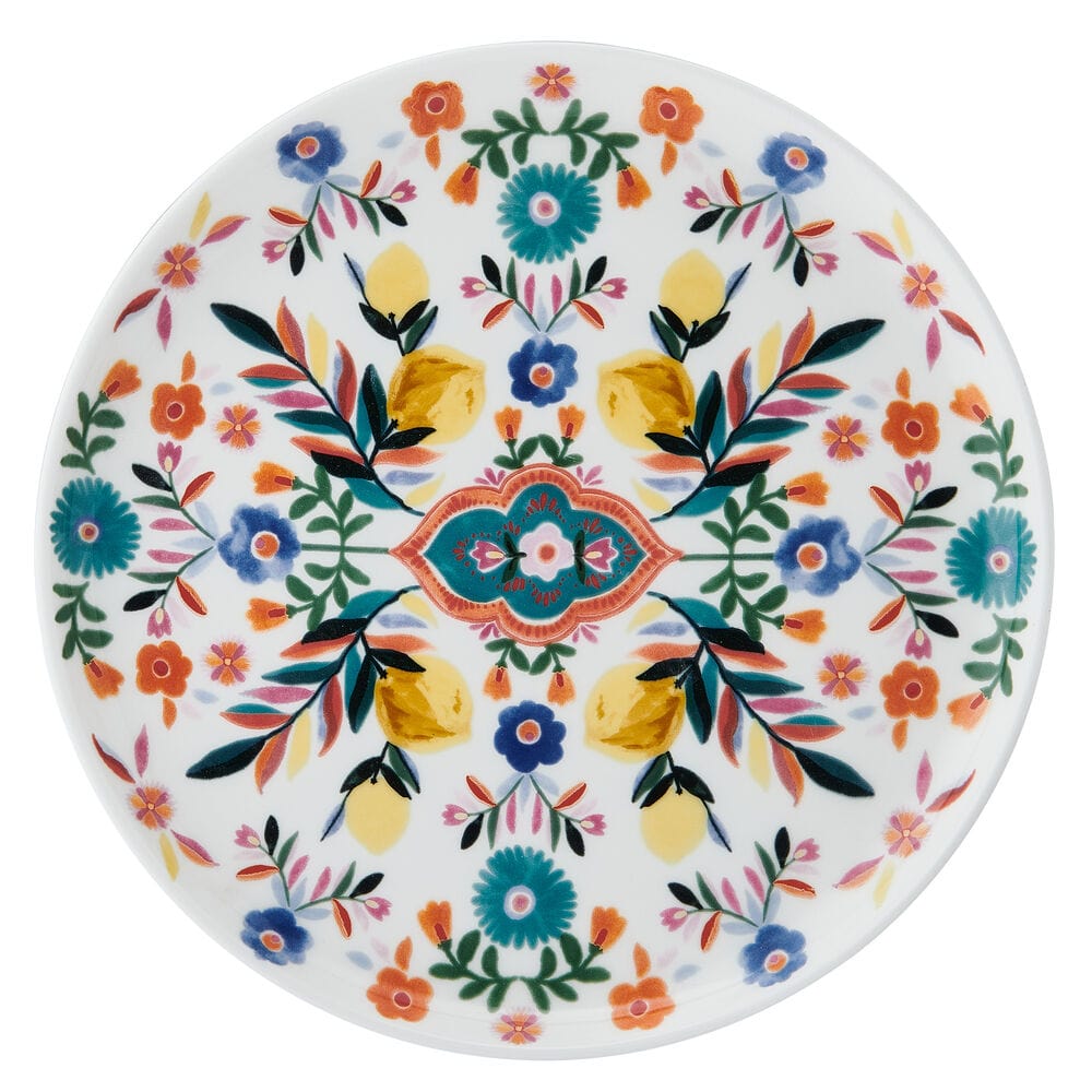 Salad plate covered in a bright floral pattern with yellow blue pink flowers and green leaves on white