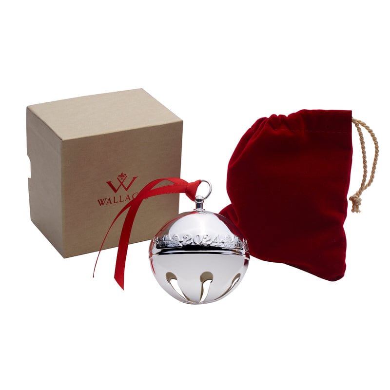 Silver plated sleigh bell ornament with red ribbon beside a brown Wallace box and red drawstring pouch