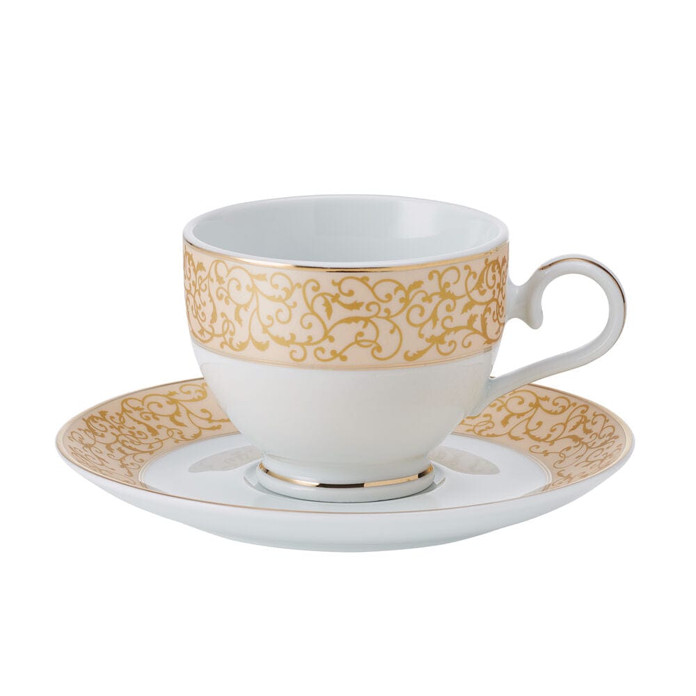 White teacup and matching saucer with ornate parchment gold band around rims