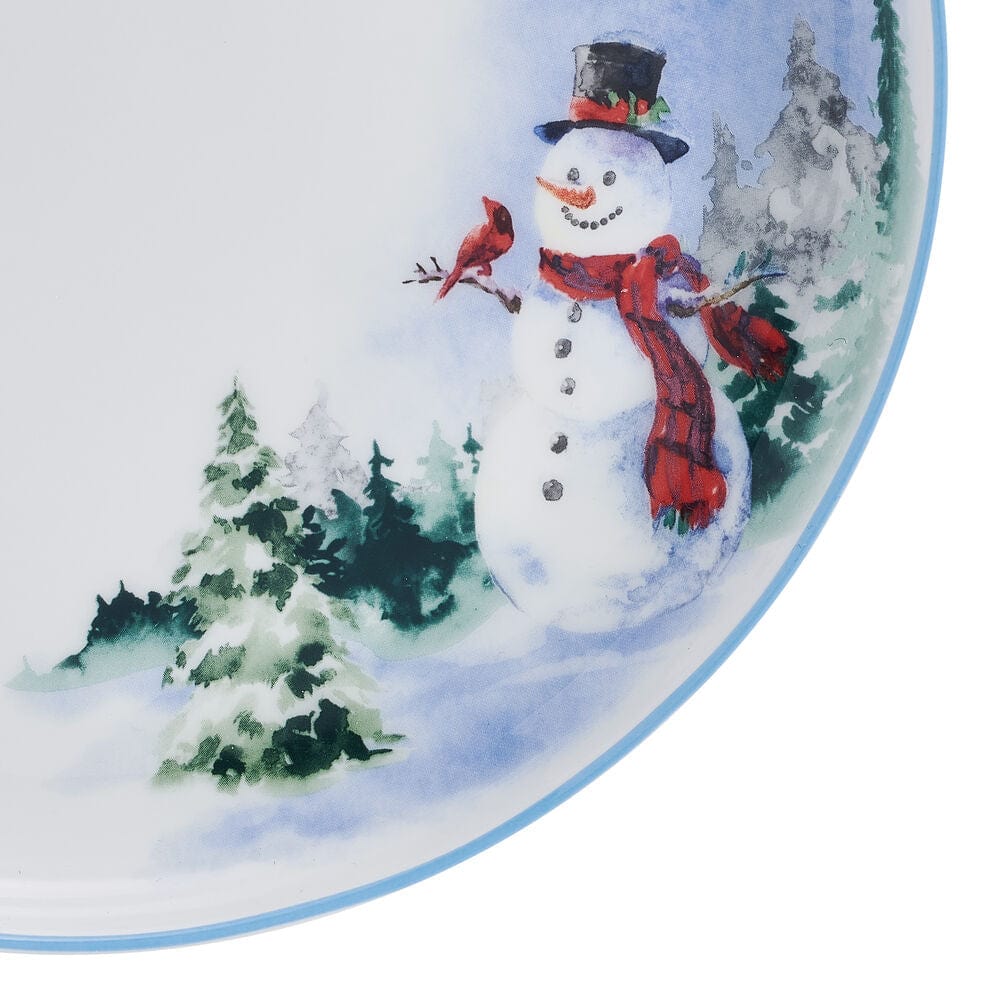 Close up of a Snowman Forest dinner plate depicting a snowman with evergreen trees on a snowy landscape