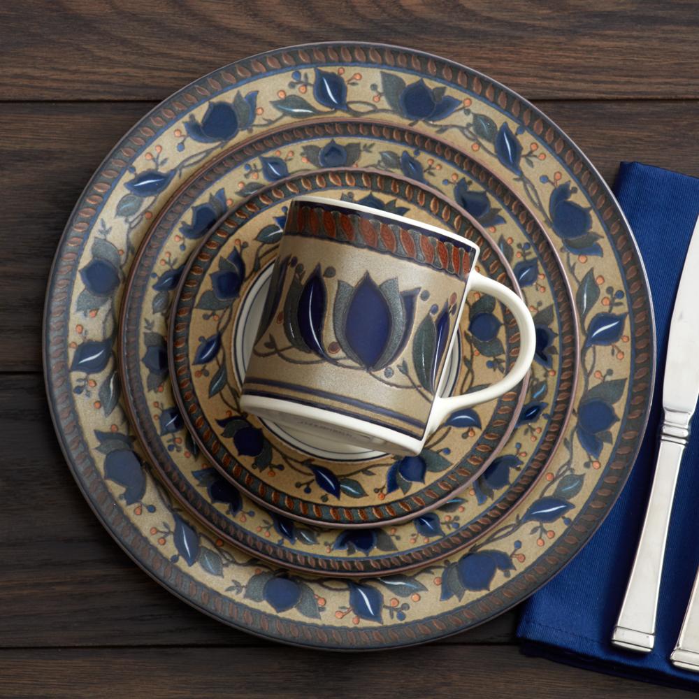 Top view of Arabella salad plates stacked with a coordinating mug on top, showing blue floral borders.