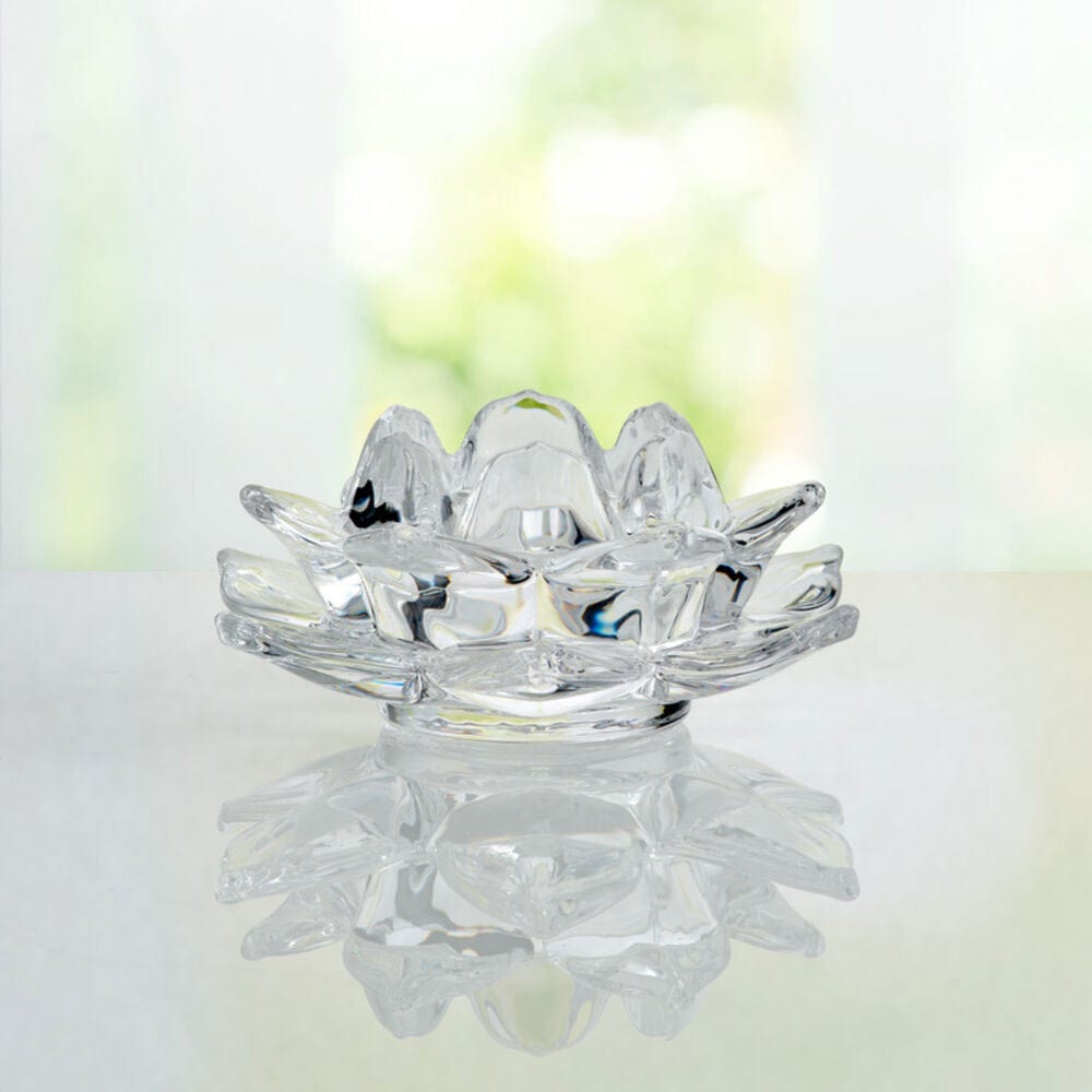 Crystal flower votive holder on a reflective surface