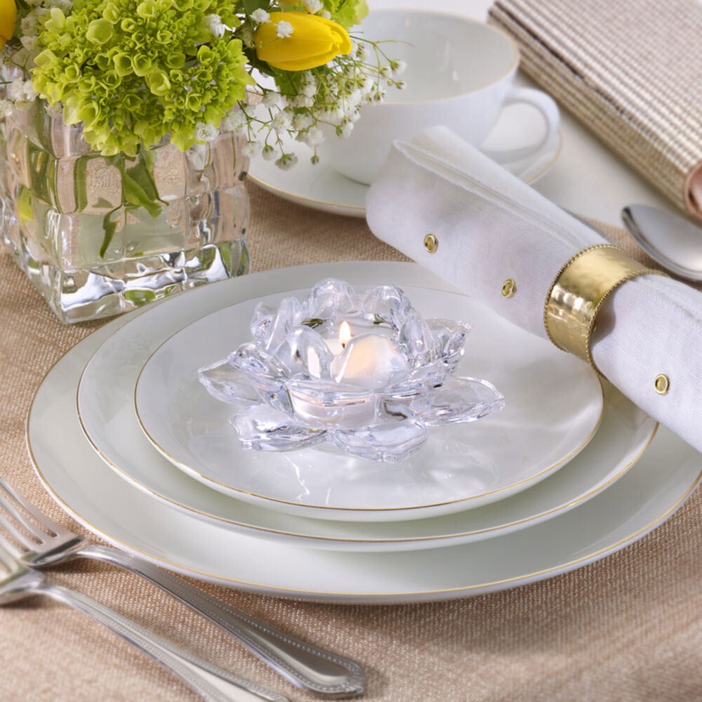 Crystal flower votive candle holder set on a formal dining place setting