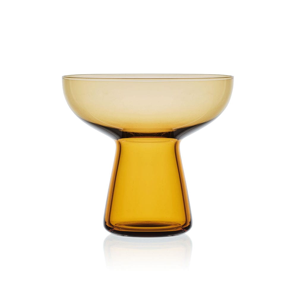 Amber margarita glass with a wide bowl and thick pedestal base against a white background.