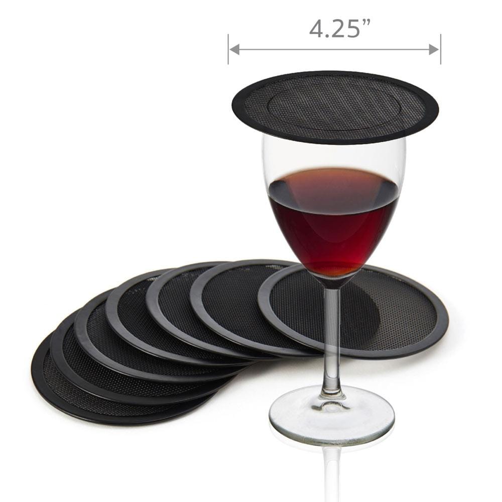 Eight black round drink covers and coasters arranged under a wine glass