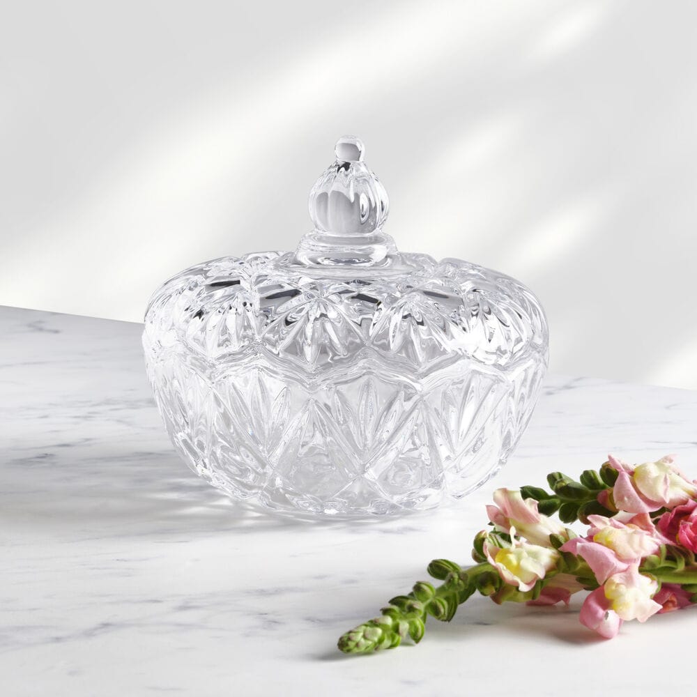 Saturn Glass Covered Candy Dish on a marble surface with its faceted crystal body and lid
