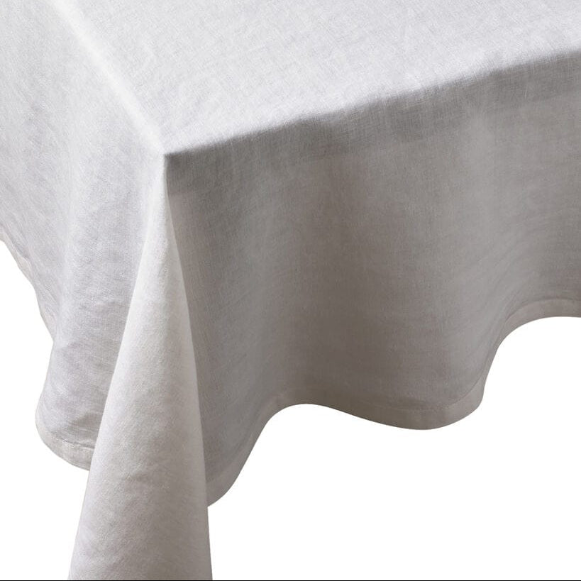 Moon White European Linen 55 x 110 tablecloth draped over a table edge