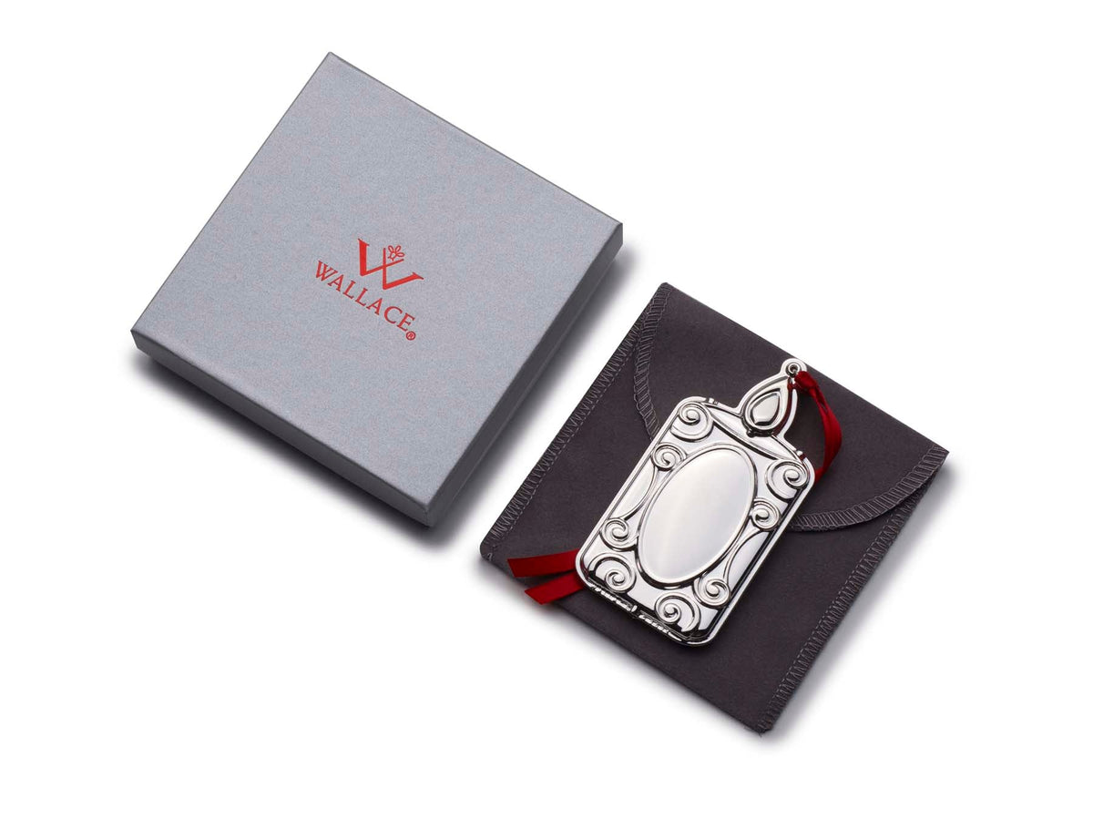 Ornament displayed with Wallace gift box and black presentation pouch for the 2025 Silver Plate Engravable Candle Ornament 13th Edition