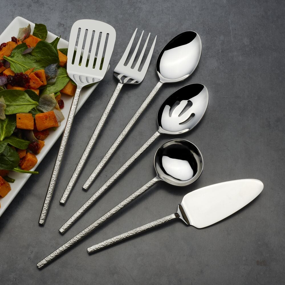 Paragon forged six piece serving set with hammered handles beside a colorful salad on a slate background