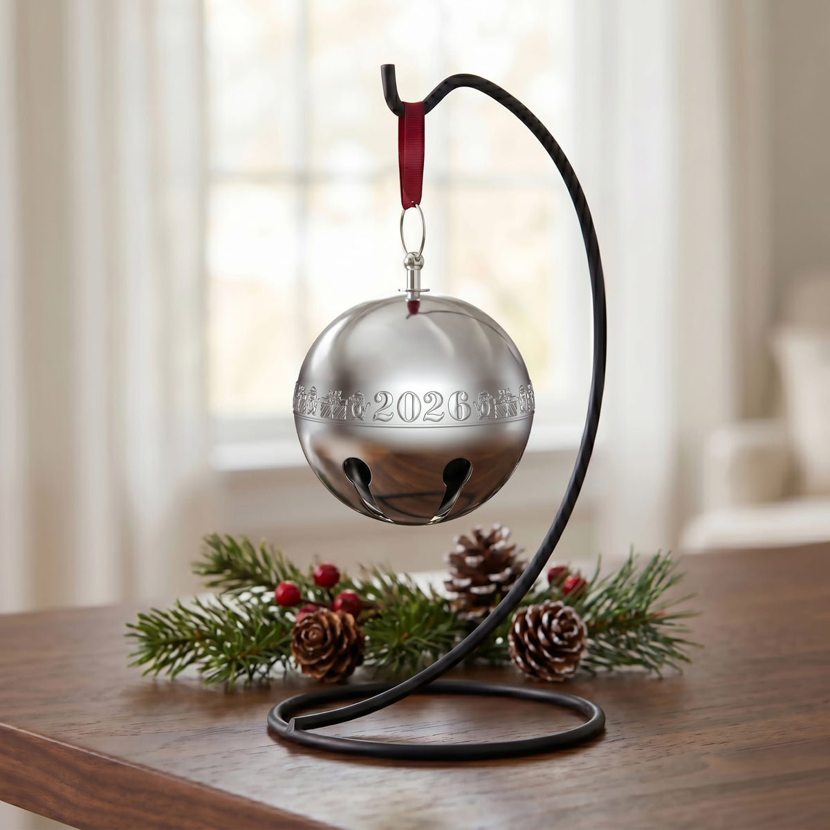 Wallace 2026 silver plated sleigh bell ornament hanging from a red ribbon