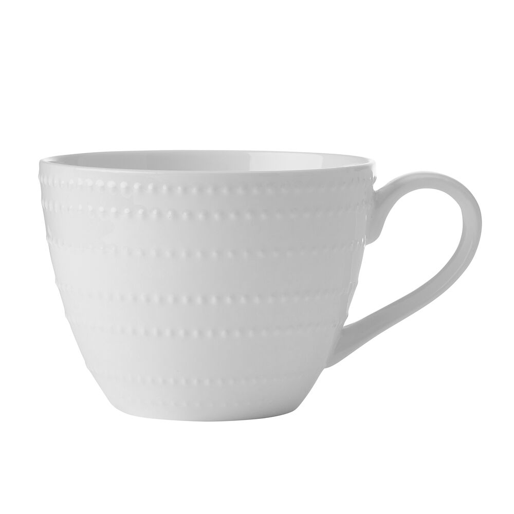 White teacup with raised dotted pattern and a curved handle on a plain white background