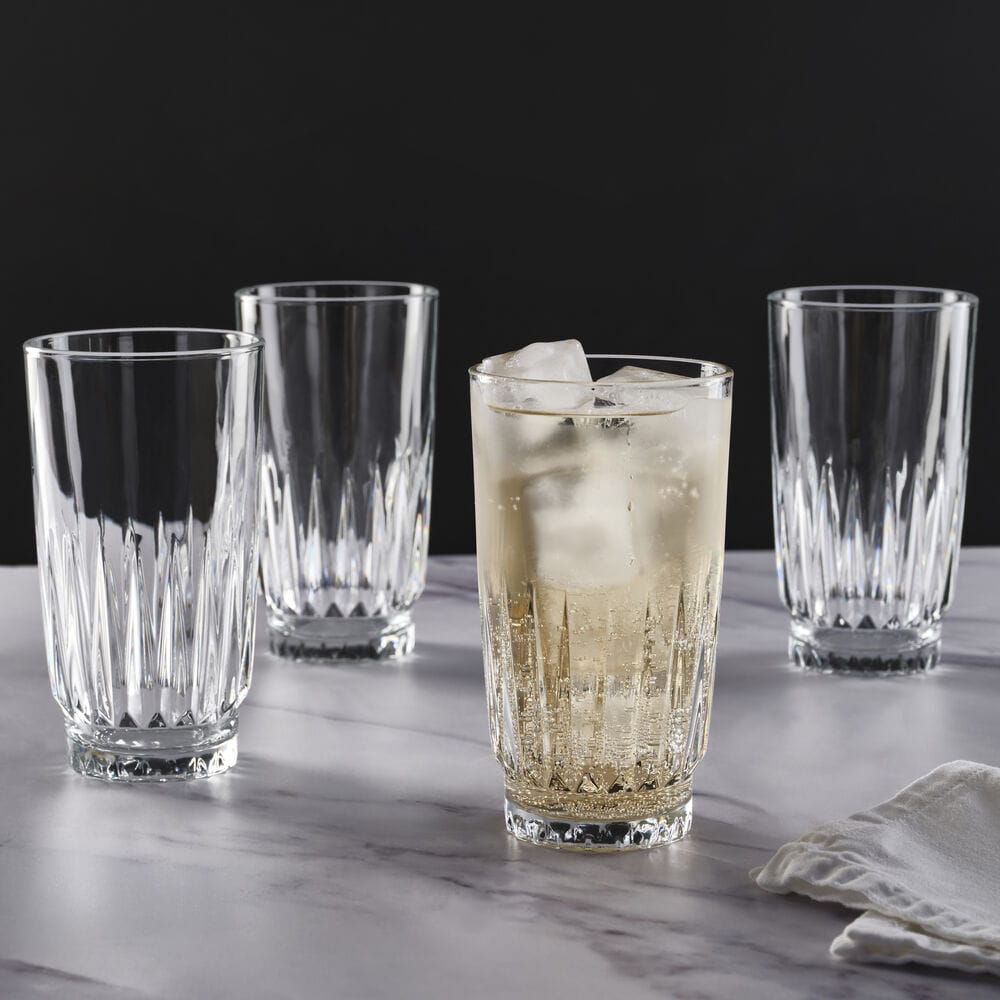 Four clear Hampshire highball glasses around a lemon drink with ice on a marble table