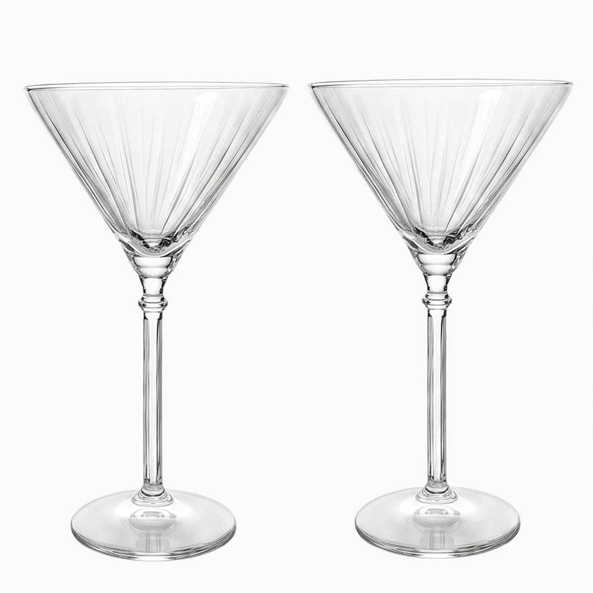 Two Eloise martini glasses with ribbed bowls and long stems, empty.