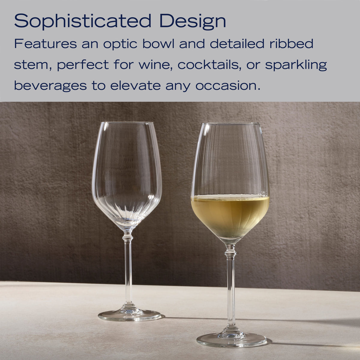 Eloise set of two ribbed wine glasses on a brown backdrop, one partially filled with pale yellow wine