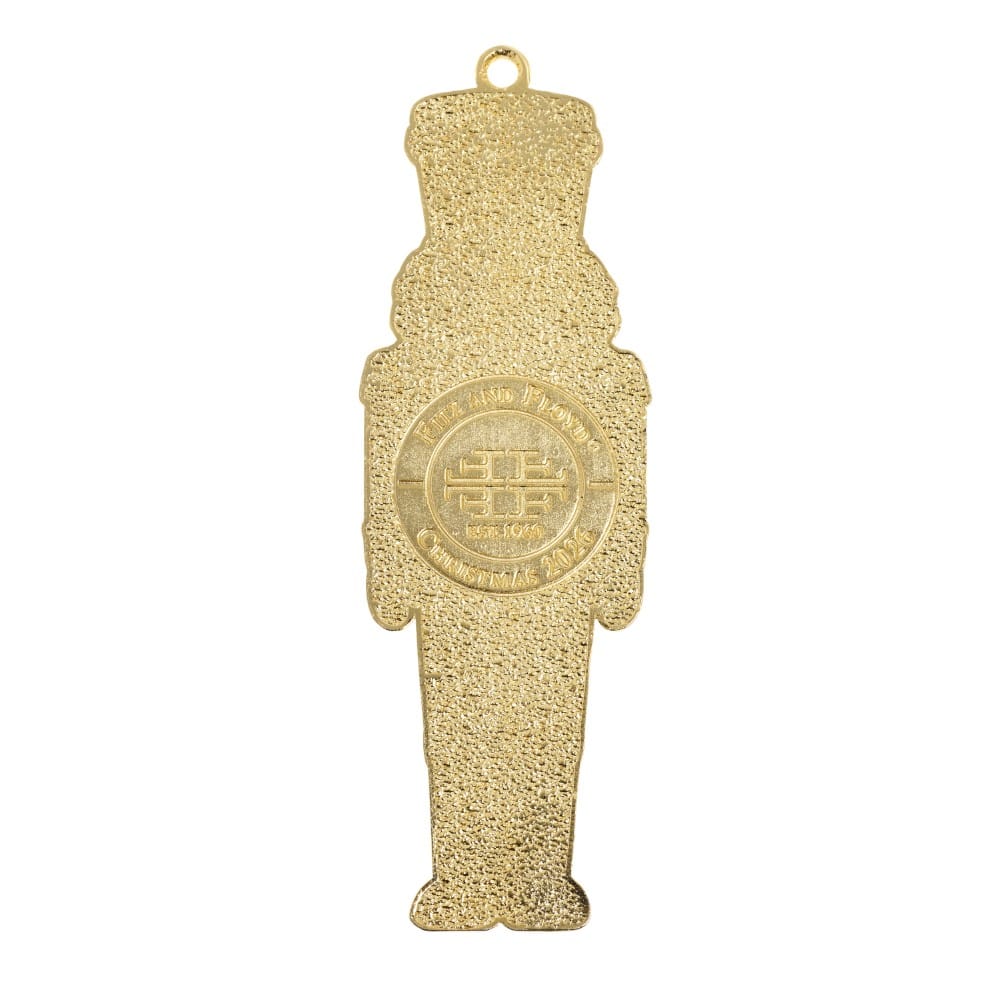 Gold plated enameled nutcracker ornament silhouette with textured surface and hanging loop