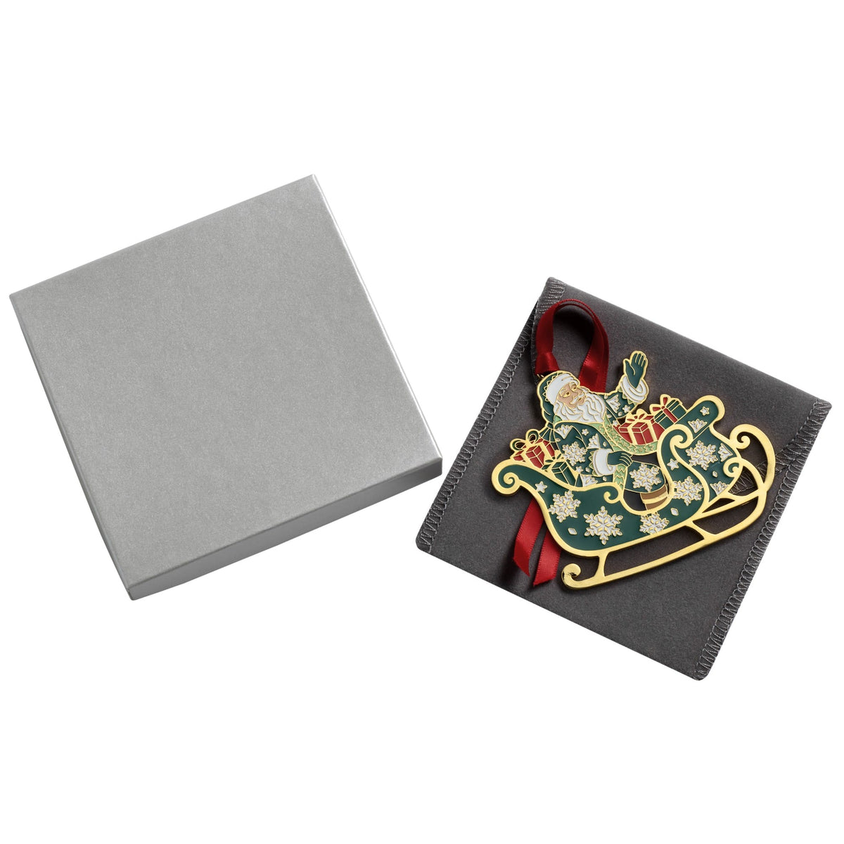 Silver gift box and dark wrapped present with red ribbon and a gold Santa ornament attached