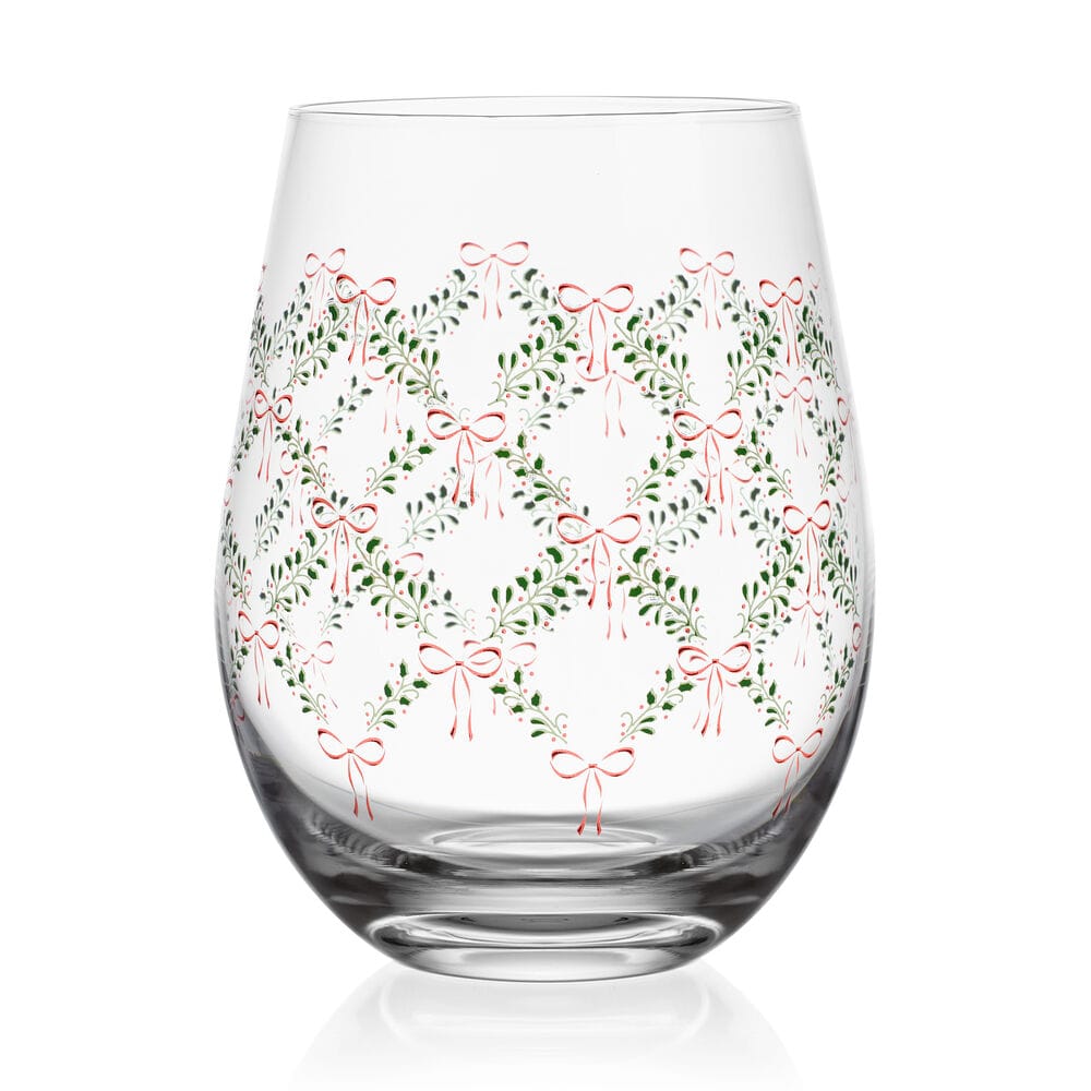 Close-up of a stemless wine glass showing green garland and red bow pattern from Holiday Bows Coquette set.