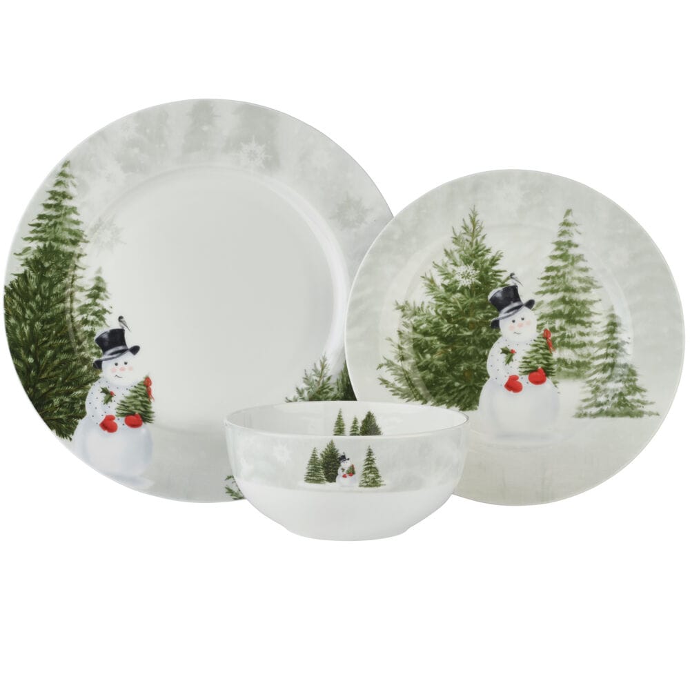 Snowmans Winter dinnerware set with plates and a bowl featuring a snowman and evergreen trees motif.