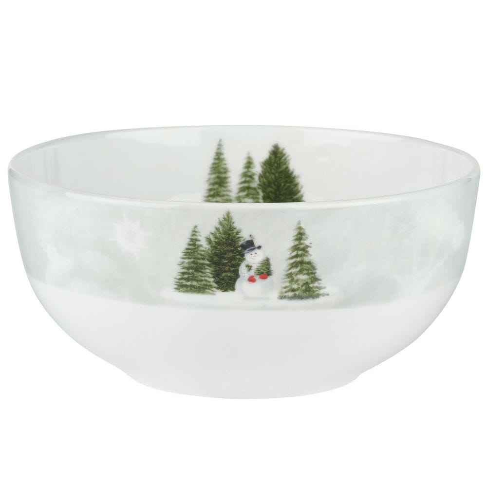 White ceramic dinner bowl with a snowy forest scene including a snowman and evergreen trees.
