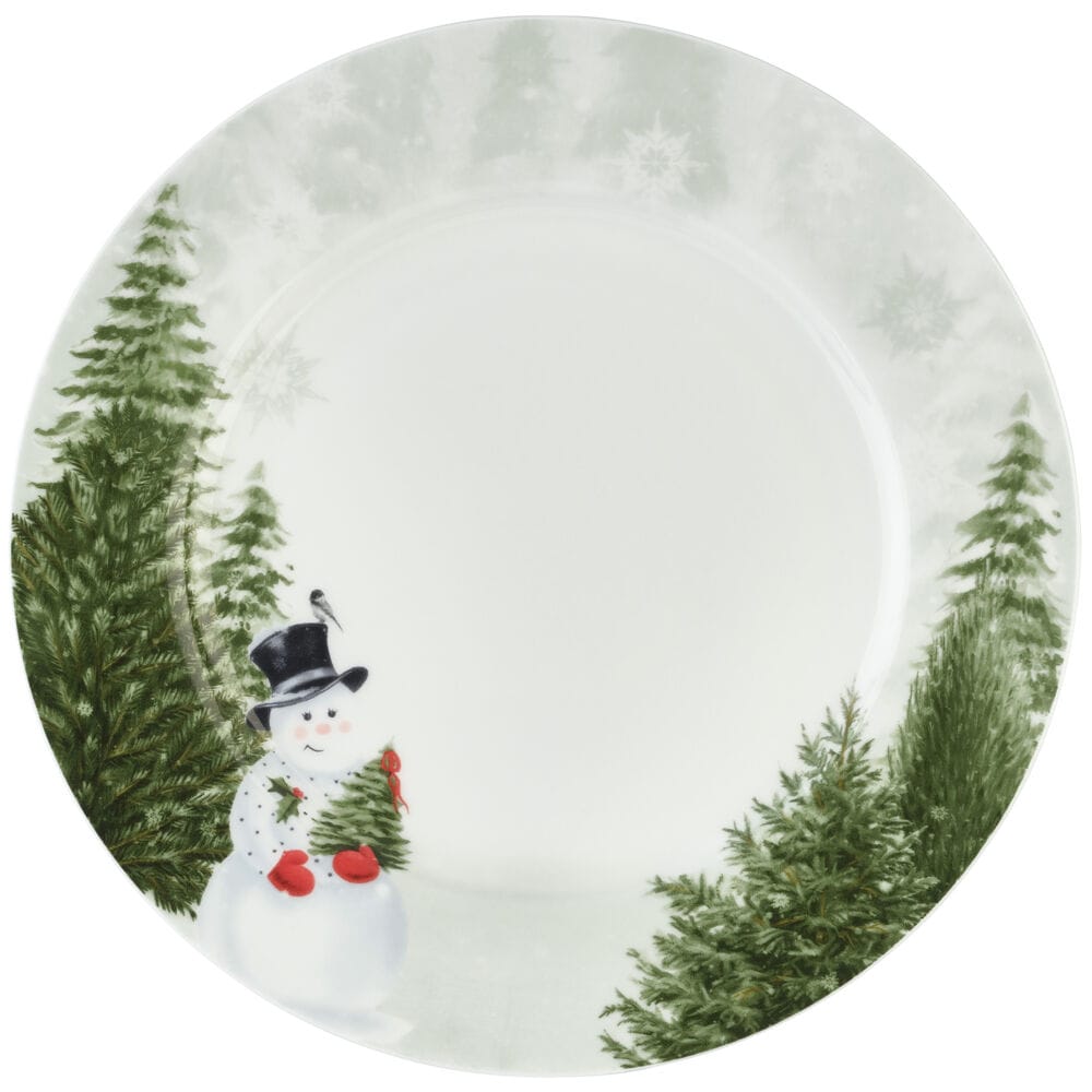 Close-up of a Snowman's Winter plate with a snowman and surrounding evergreen trees along a pale edge.