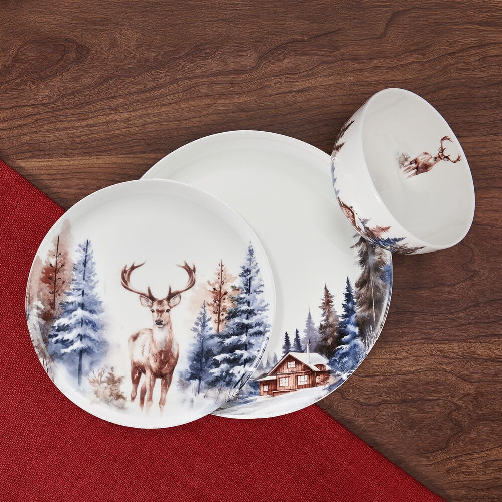 Whispering Pines dinnerware close up showing a deer and cabin woodland scene on a white plate