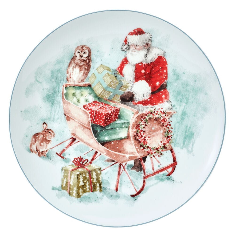 Plate from the Magical Santa set showing Santa in red beside a sled with gifts, an owl on the sled and a rabbit nearby.