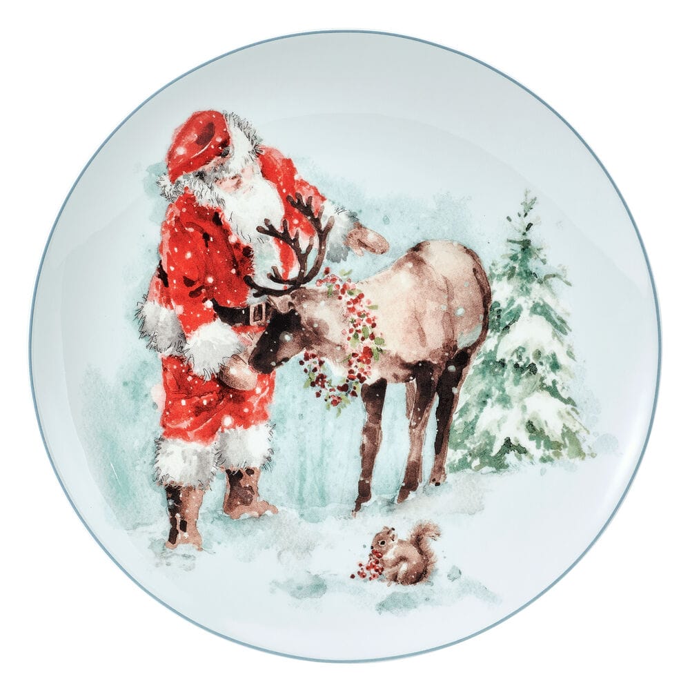 Santa in a red suit with a reindeer in a snowy scene on a decorative salad plate.