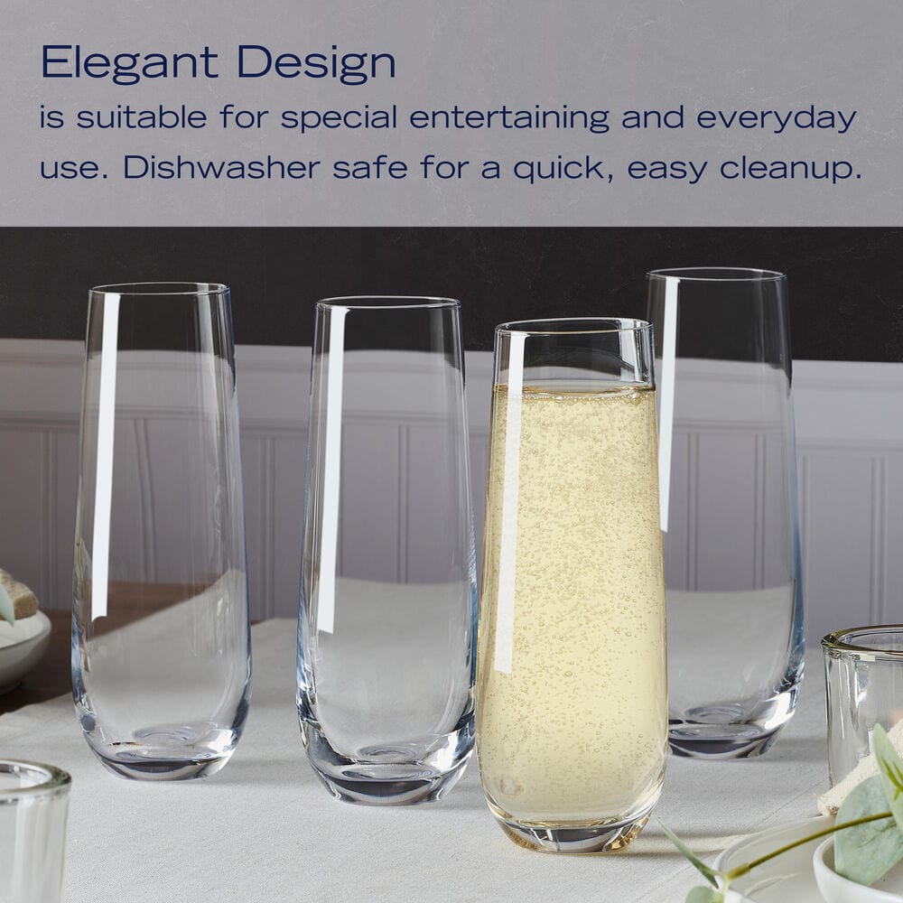 Tall stemless champagne flutes arranged on a table with one glass of sparkling beverage highlighting an elegant tapered design.