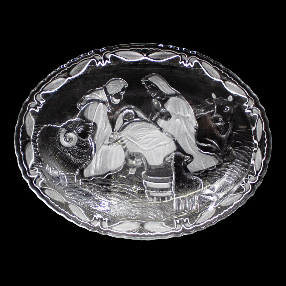 Close up of nativity plate edge with scalloped border and intricate relief details.