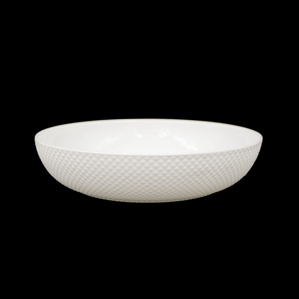 Single white pasta bowl with a diamond textured exterior on a black background.