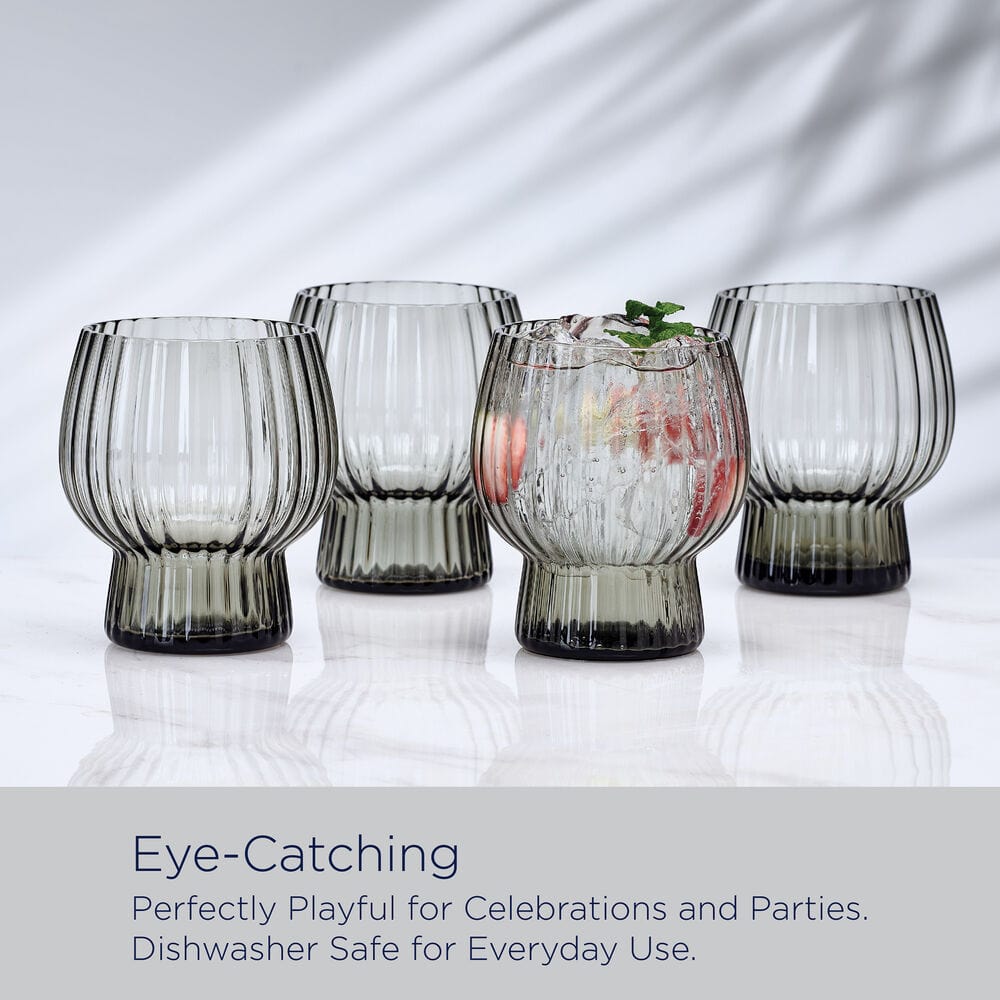 Four Phoebe Optic Smoke double old fashioned glasses arranged in a row on a reflective surface with a light gray caption bar.