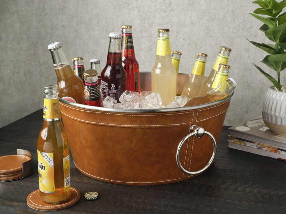 Brown faux leather beverage tub filled with assorted bottles and ice on a dark wood table.
