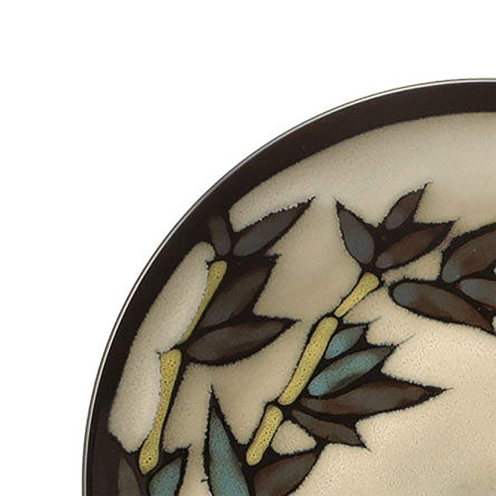 Partial view of Belmont Round Blue Stalks dinner plate with brown leaves on a beige background