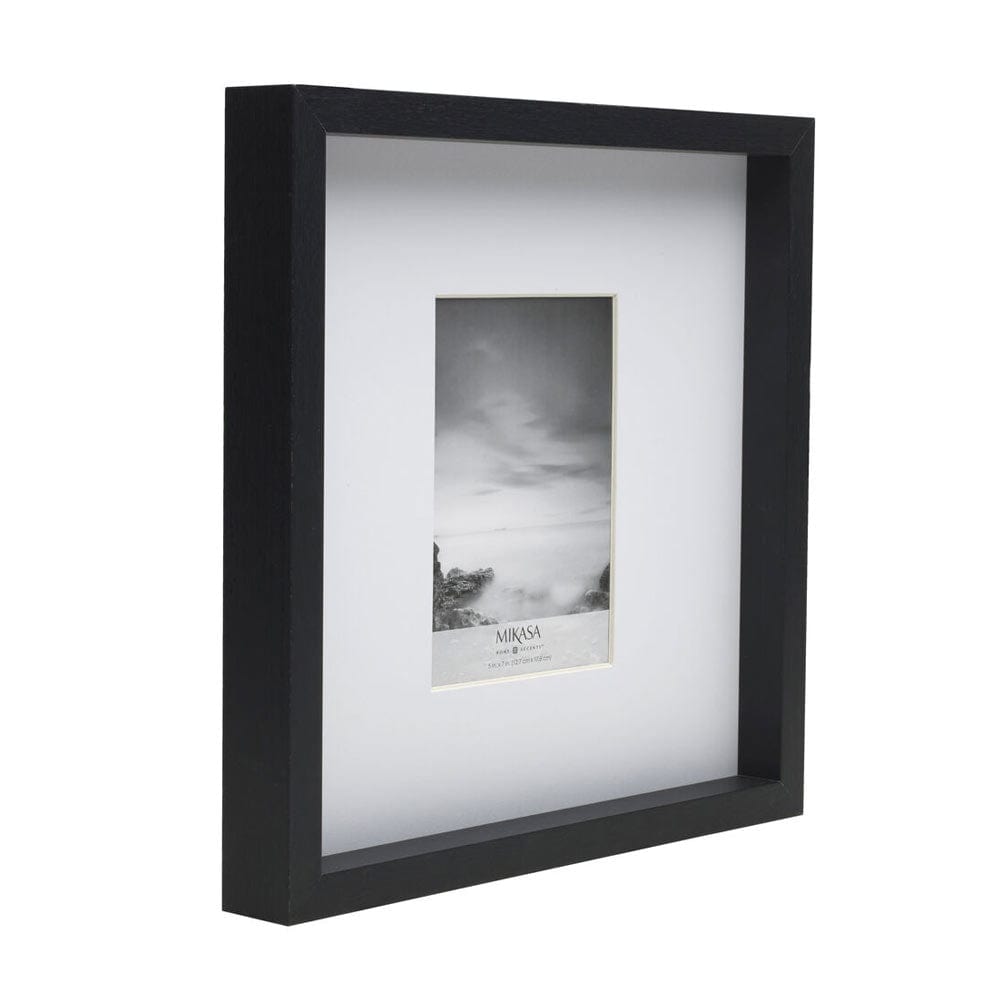 Angled view of a black 16x16 gallery frame containing a vertical 5x7 photo in a white mat.