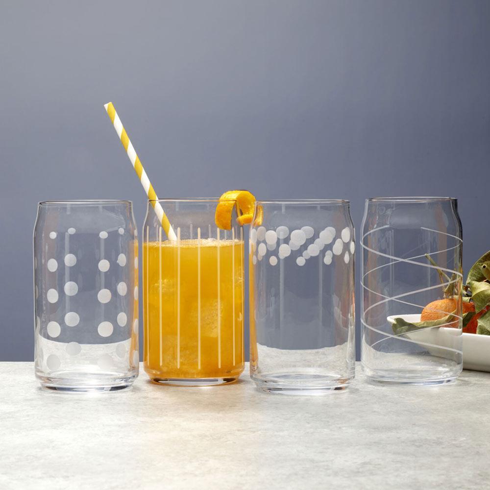 Set of four Cheers glasses with varied patterns; the middle glass holds orange juice with a striped straw