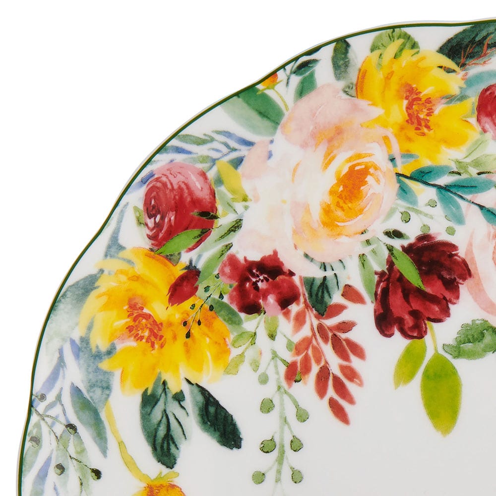 Close up of a Clara plate edge showing bright floral bouquet and a green rim
