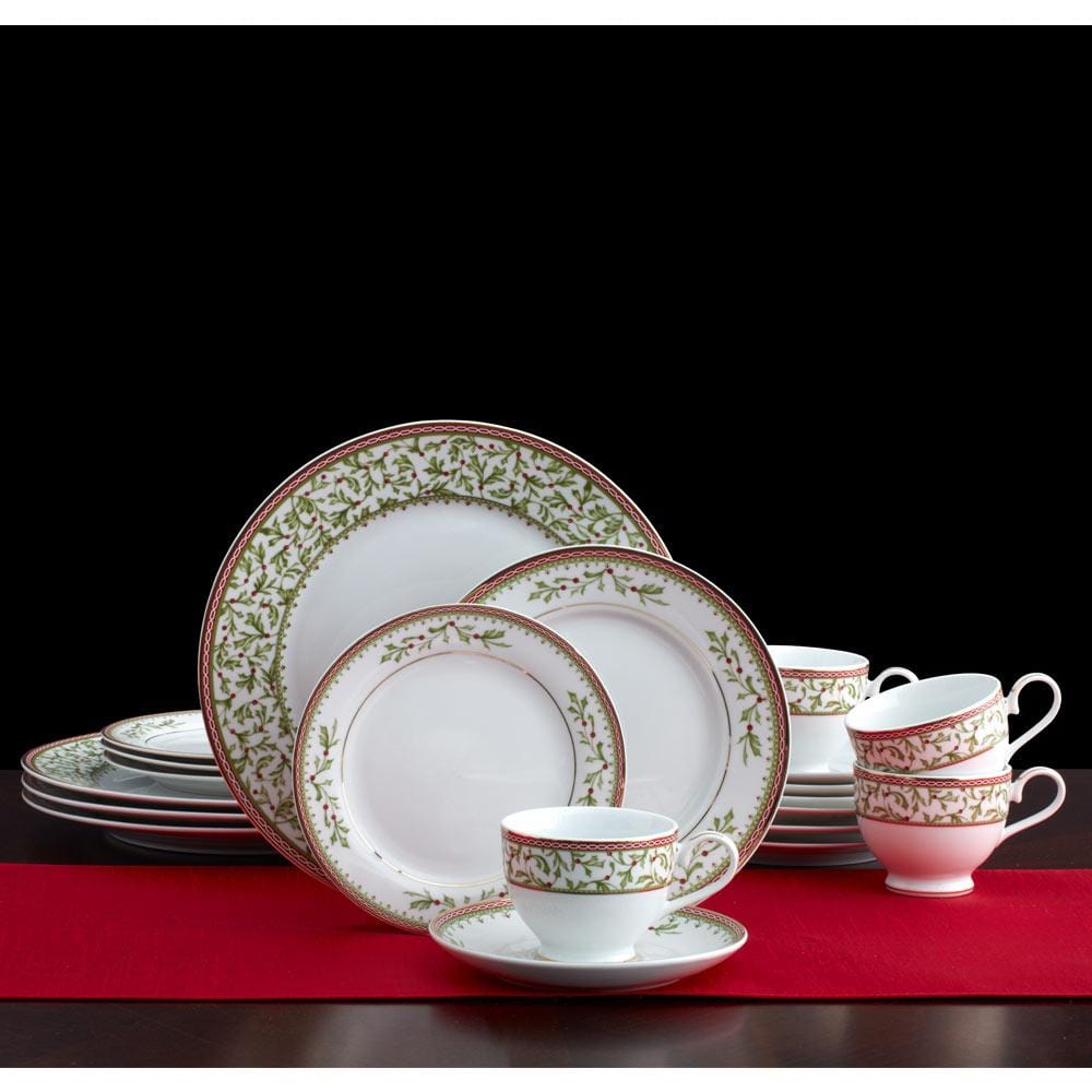Holiday Traditions dinnerware set arranged on a black background with white plates featuring gray borders and stacked teacups and saucers